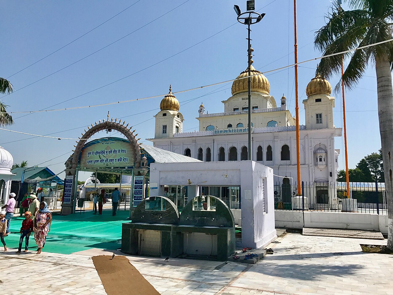 White gurdwara building with golden domes at Sri Fatehgarh Sahib in Sirhind