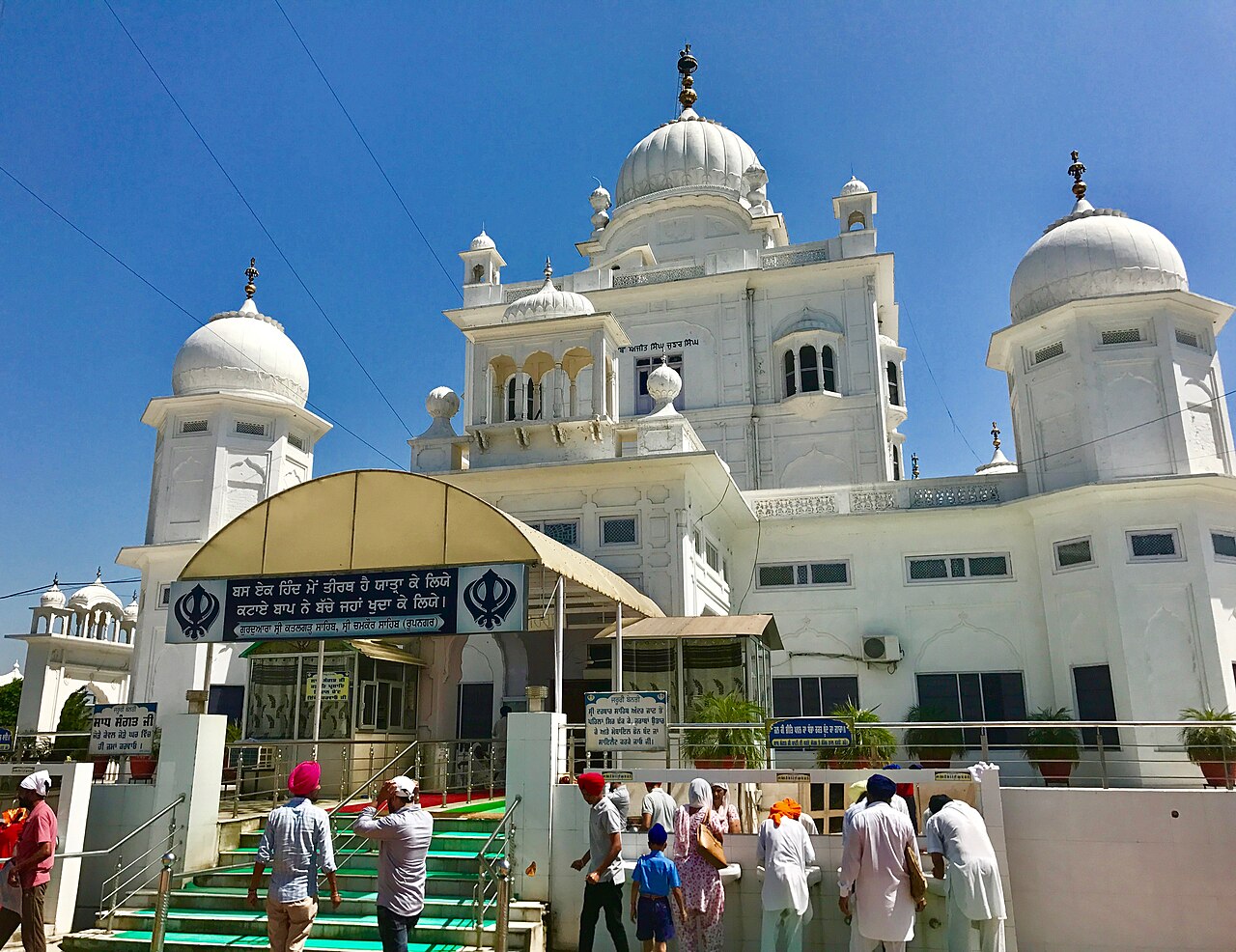 Visitors approaching the white domed Gurdwara Sri Katalgarh Sahib at Chamkaur Sahib, Punjab.